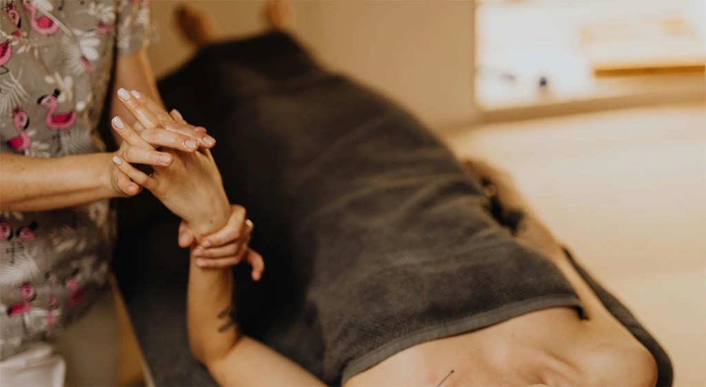 A woman getting a hand massage